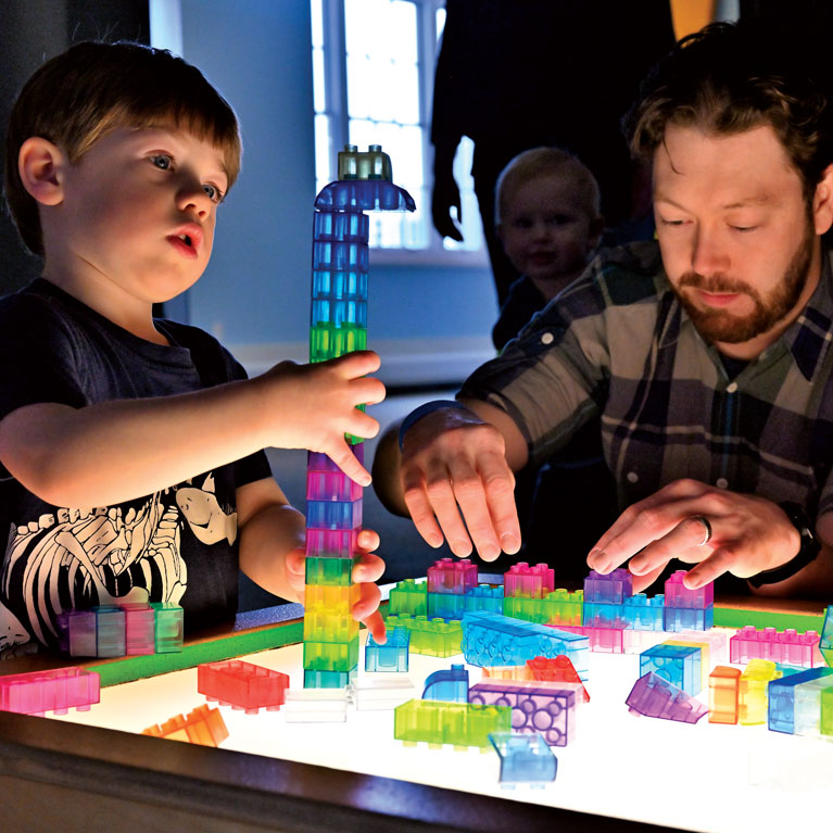 Construct colorful creations at the light table in little kidspace®.